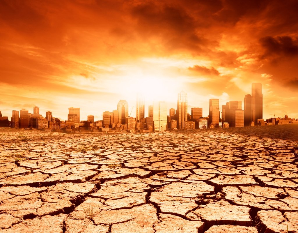 A city in flames with dried earth in the foreground.