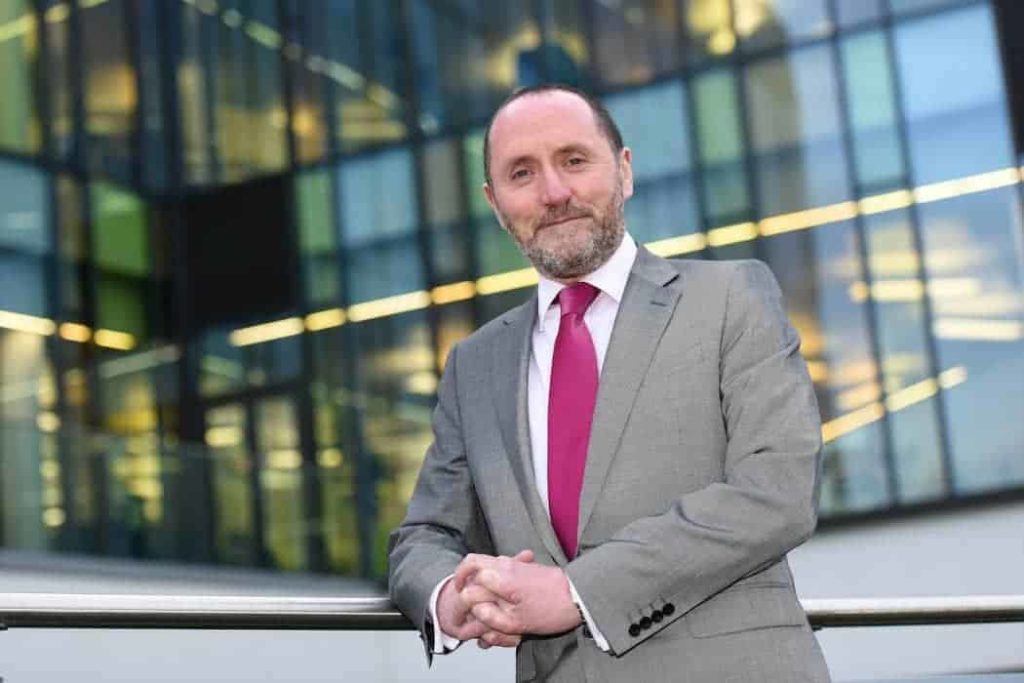 UK MP Eddie Hughes leans against a wall for portrait.