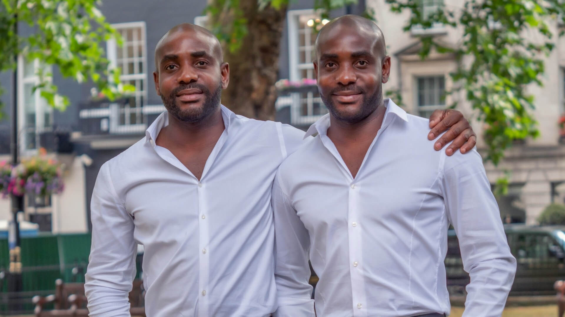 The Williams twins stand together in a park.