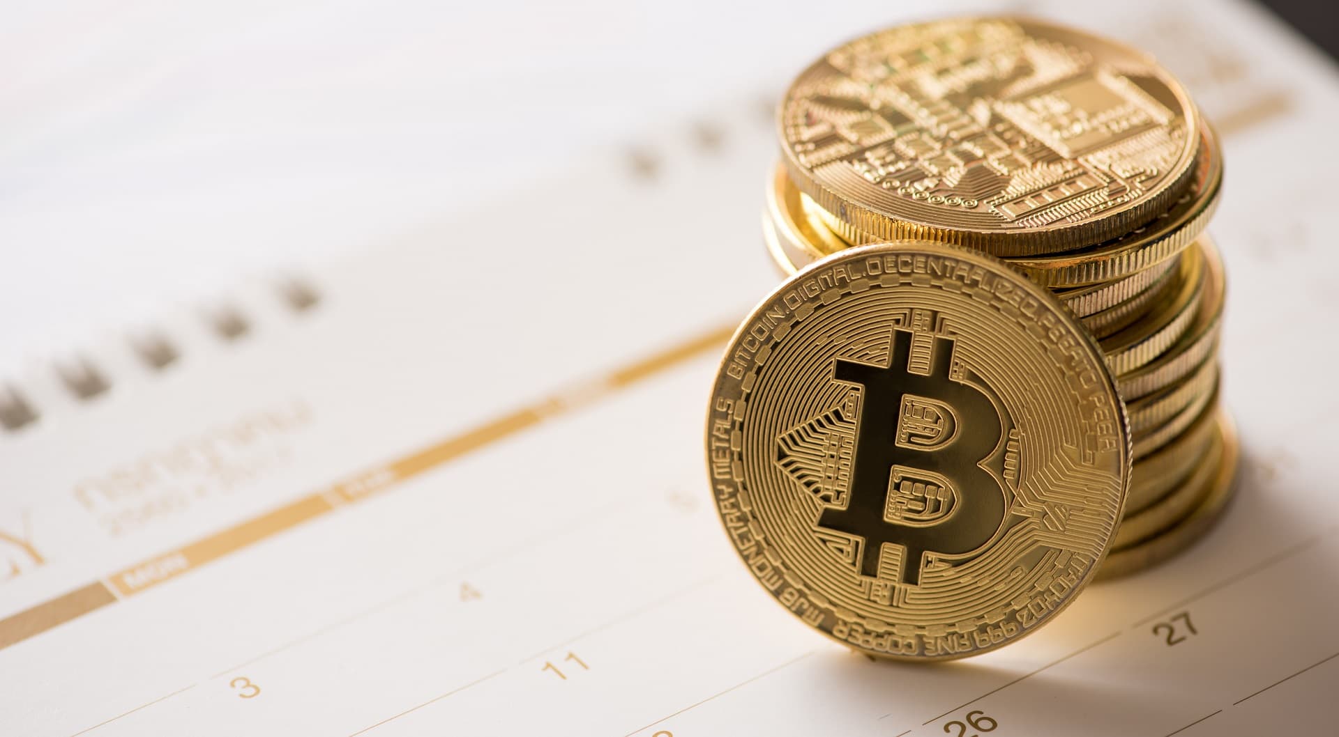 golden Bitcoin on a calendar