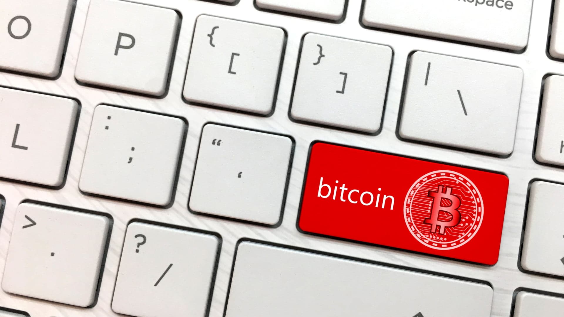 Computer keyboard button with the word bitcoin, and bitcoin symbol