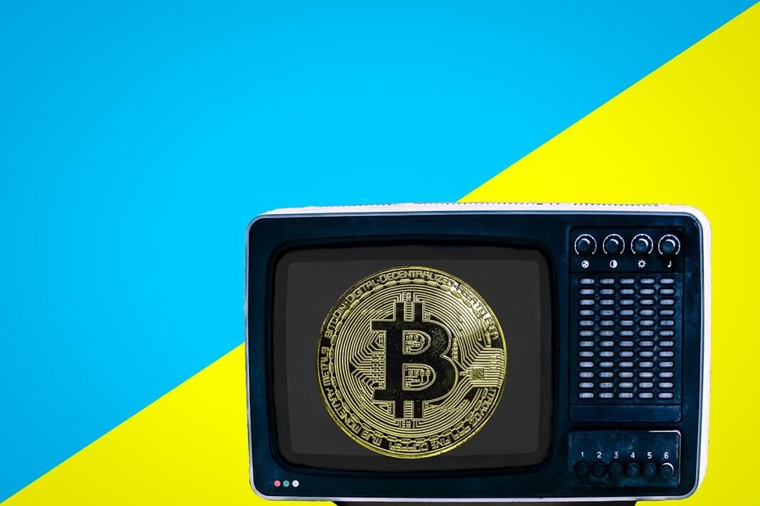 Bitcoin on the retro TV on blue and yellow background