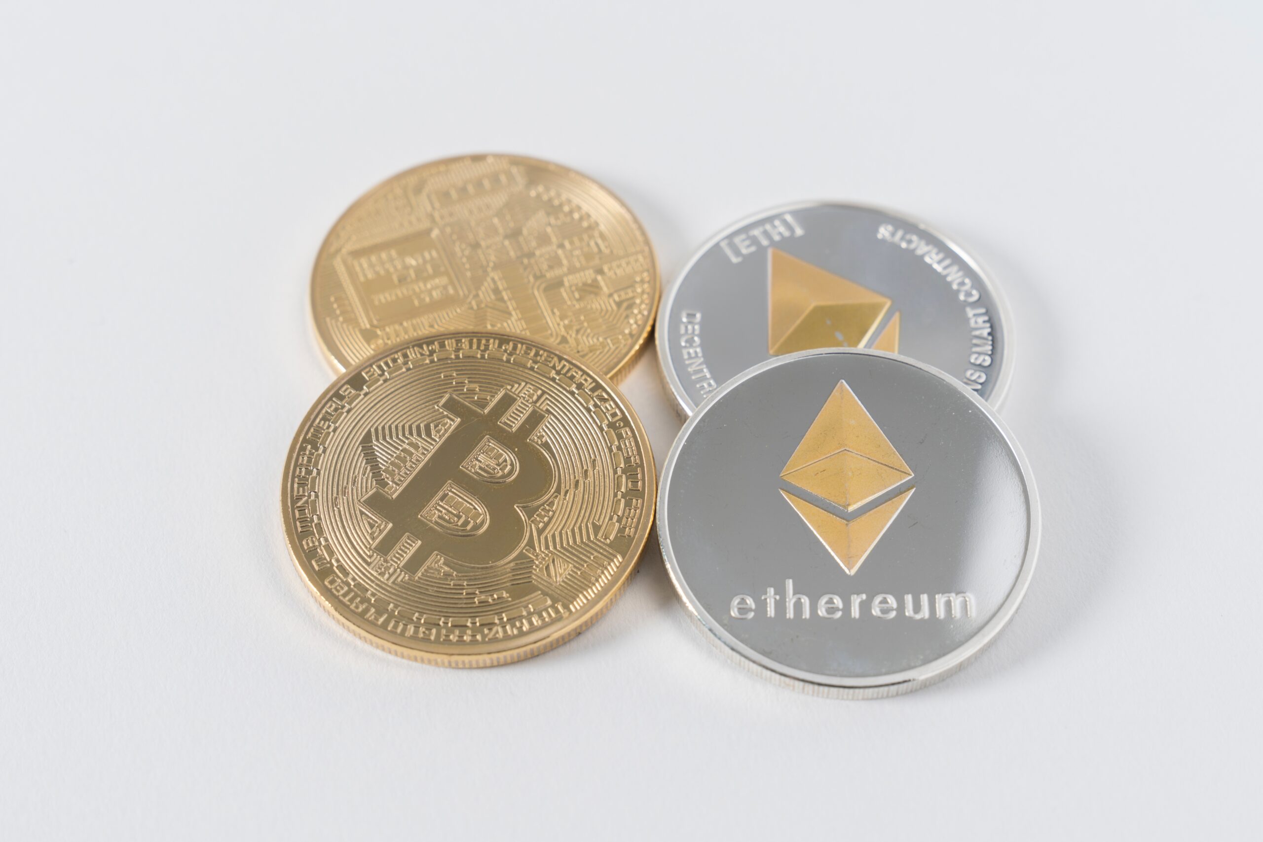 An image of a Bitcoin coin next to an Ethereum coin
