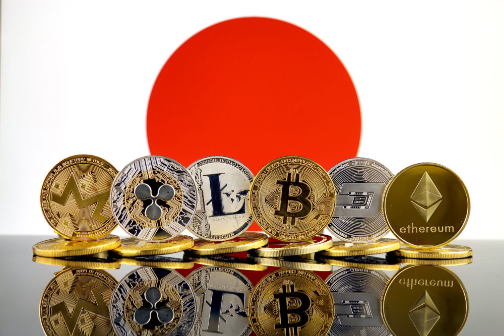 Japanese flag with a range of cryptocurrencies in front.