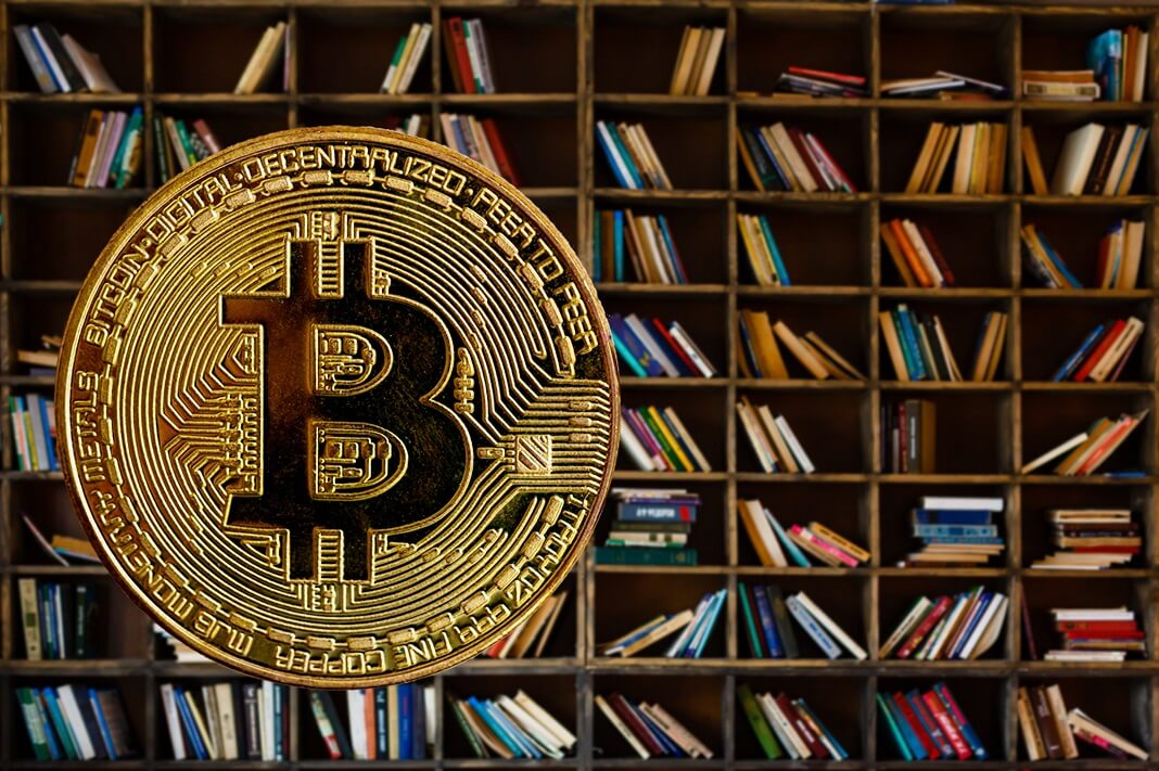 bitcoin with books in the background