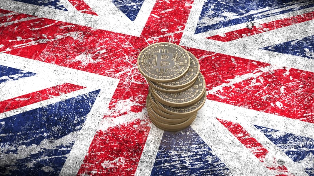 A pile of Bitcoin coins stands on the flag of Britain