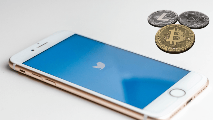 Twitter app on the smartphone screen with cryptocurrencies on the side